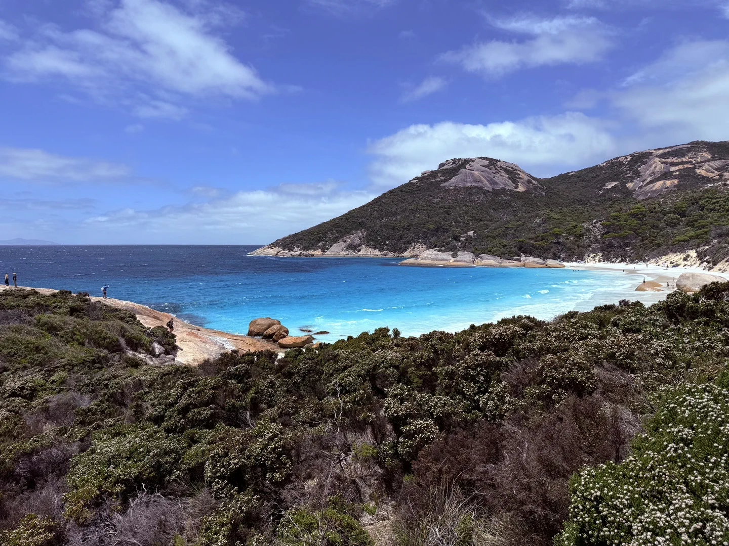 A picture of the crescent shaped beach, with pristine blue water